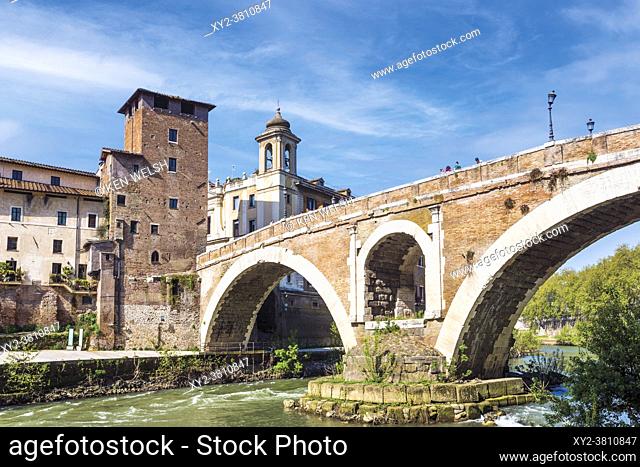 Rome, Italy. Isola Tiberina or Tiber Island with the Ponte Fabricio built in the first century BC. The historic centre of Rome is a UNESCO World Heritage Site