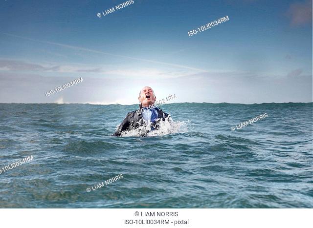 A businessman coming out of the sea