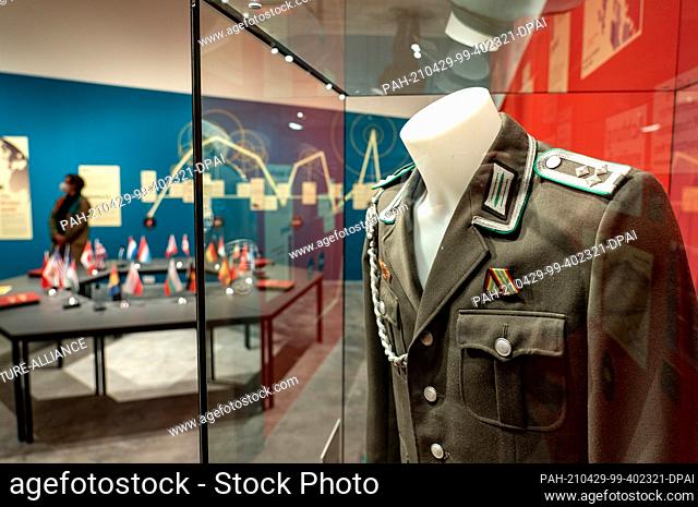 29 April 2021, Schleswig-Holstein, Molfsee: A woman looks at the exhibits in the special exhibition on the Cold War in the Jahrhunderthaus at the Molfsee...