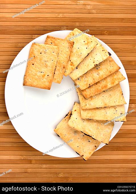 yellow cookies on white plate on bamboo napkin