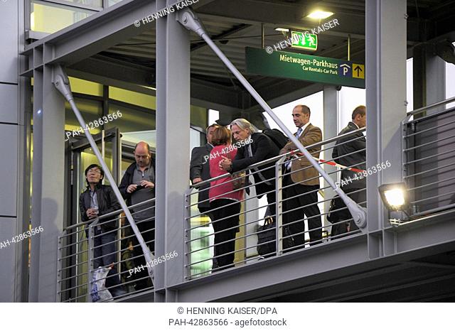 Passengers wait on a bridge between a parking garage and the terminal at the airport in Duesseldorf,  Germany, 24 September 2013