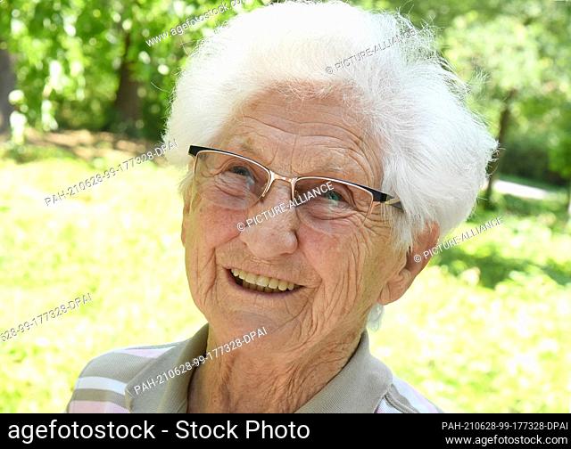 28 June 2021, Saxony, Bad Düben: 95-year-old Johanna Quaas from Halle/Saale stands laughing in the park at the Mediclin Rehab Center in the Waldkrankenhaus Bad...