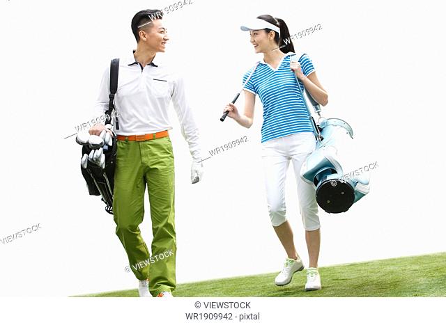 Young people playing golf