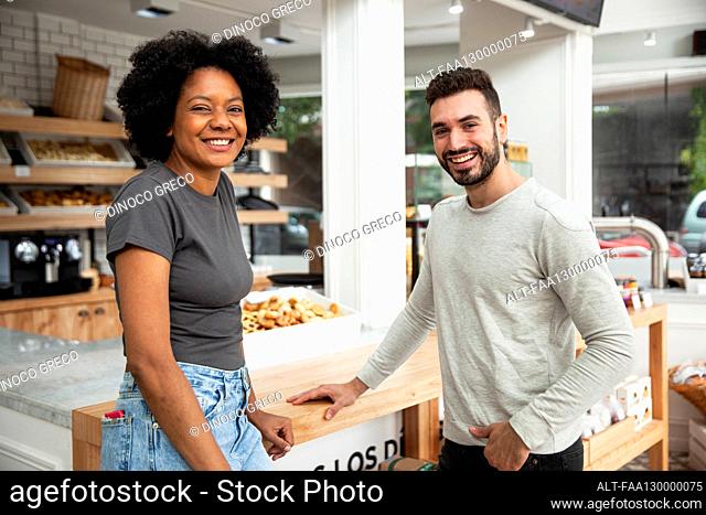 Female and male entrepreneur looking at the camera
