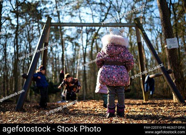 10 March 2022, Lower Saxony, Lüneburg: Orphans from Ukraine swinging on a playground. 31 Ukrainian orphans have arrived safely in Lüneburg and are staying in...