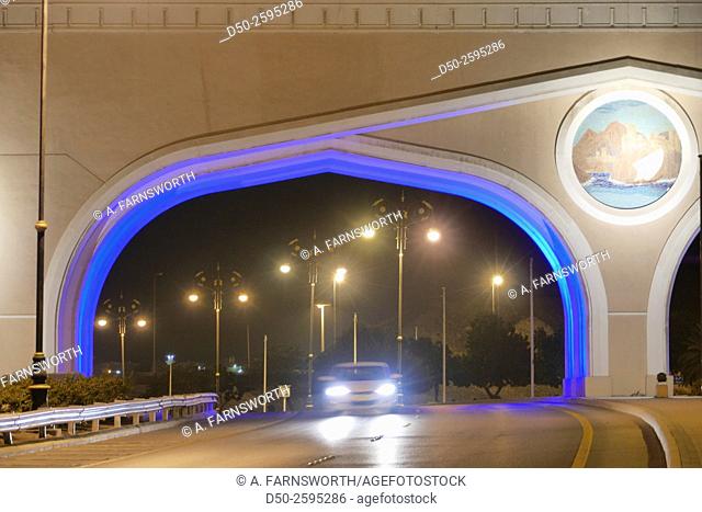 MUSCAT, OMAN Illuminated entrance gateway by road to the Muttrah and Sultan Qaboos port. Urban beautification