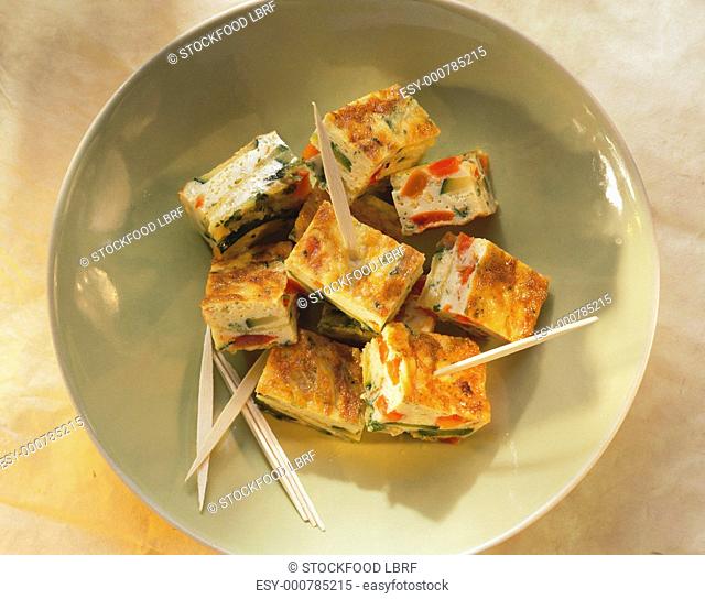 Courgette & pepper tortilla in small pieces with wooden skewers