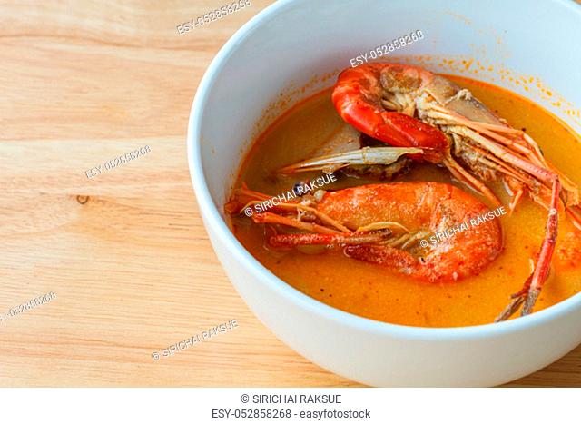 Thai spicy soup shrimp, Bowl of spicy Thai Tom Yum Soup on wooden background
