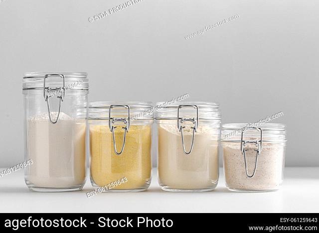 close up of jars with different flours on table
