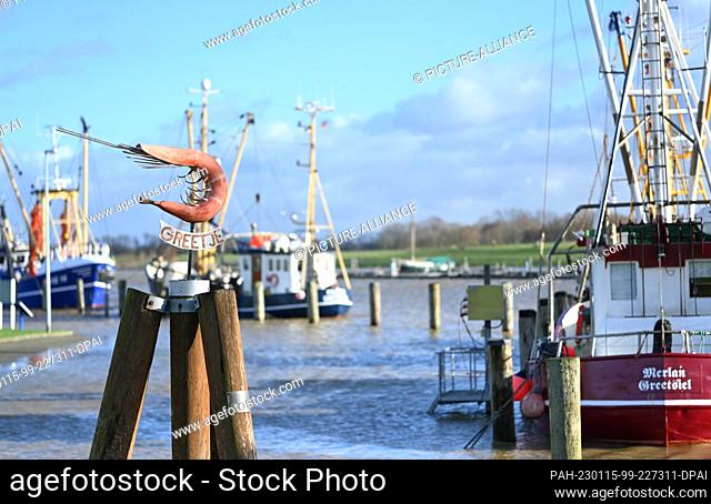 15 January 2023, Lower Saxony, Greetsiel: The precipitation of the last few days and the successive storm surges in the North Sea cause flooding in the harbor...