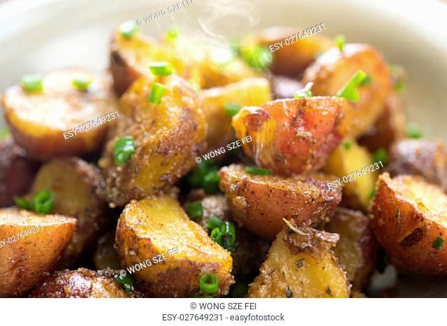 Close up freshly oven roasted baby potatoes with skin on plate