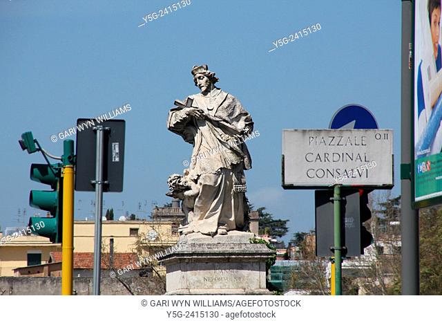 Priest holding cross statue by ponte milvio bridge in Rome Italy