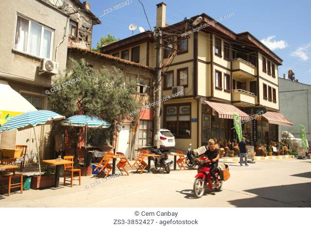 Motorcyclist in front of the traditional Ottoman houses at the town center of Tirilye also known as ZeytinbaÄŸÄ±, Mudanya, Bursa Province, Marmara Region