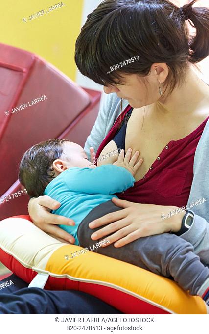Mother breastfeeding baby in ambulatory area