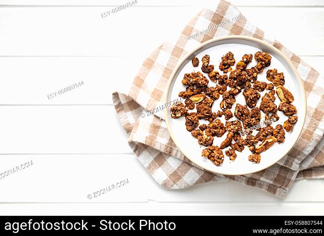 Chocolate breakfast cereal. Morning granola with milk in a bowl. Top view
