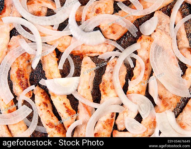 Meat Strips Fried With Onion In A Black Pan