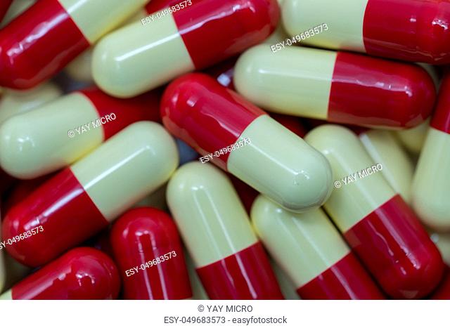 Top view of red, pale yellow, capsule pills
