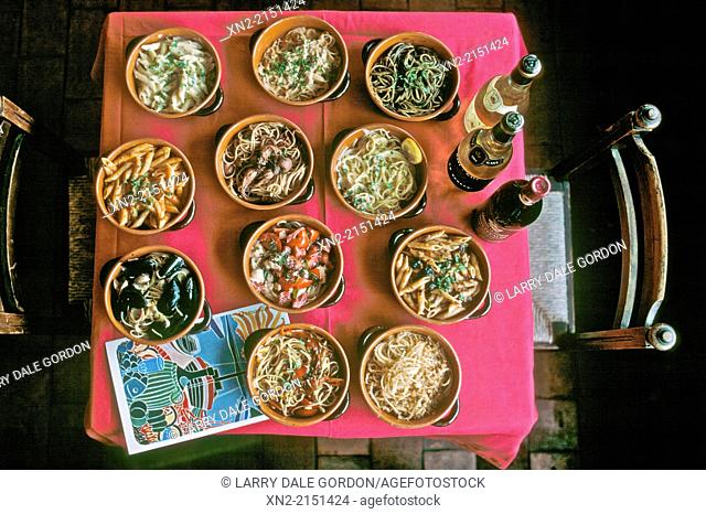 Bird's eye view of a selection of pasta dishes in a restaurant in Porto Santo Stefano, Tuscany, Italy