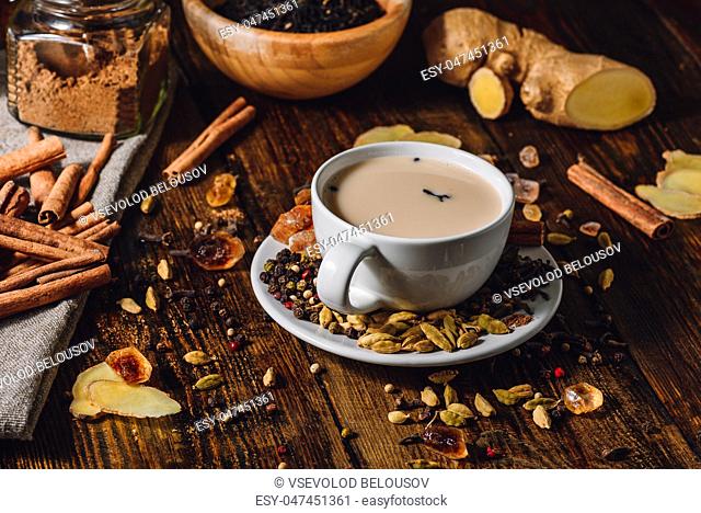 Indian Masala Tea in Cup with Ingrediants. Spicy Beverage