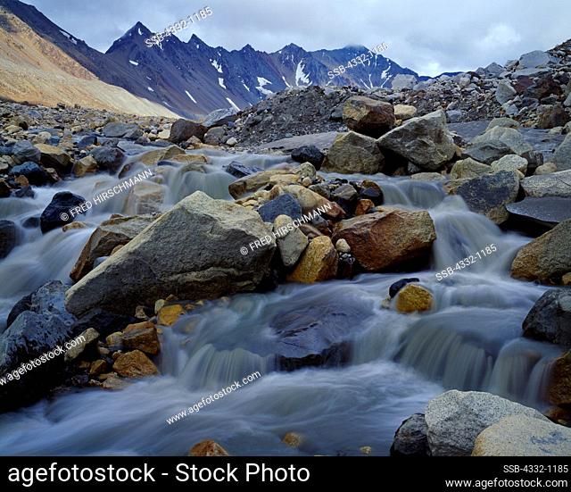 Boulder Creek flowing from glacier in the Little Cathedral Mountains, Alaska Range, Alaska