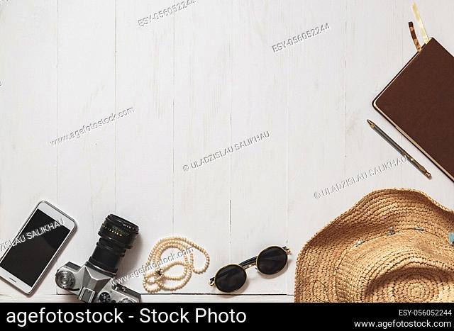 Travel Set of hipster girl: female accessories on the white planked surface