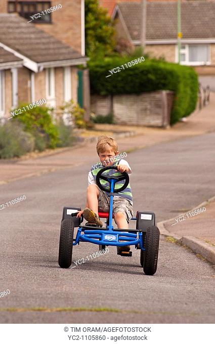 A  five year old boy on a Berg go cart in the Uk