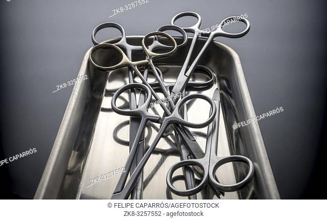 Some scissors for surgery on a tray, conceptual image, horizontal composition