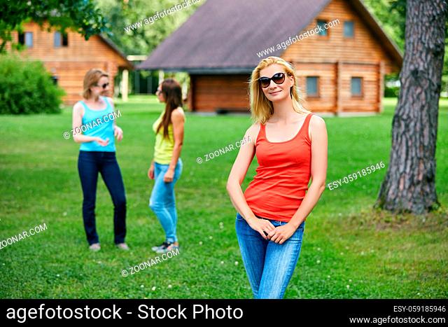 three beautiful young women spending time ourdoors in countryside. friends having fun. Outside shot. Copy space