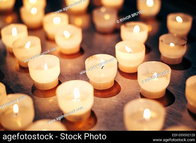 Group Of Candles In Church. Candles Light Background. Candle Flame At Night