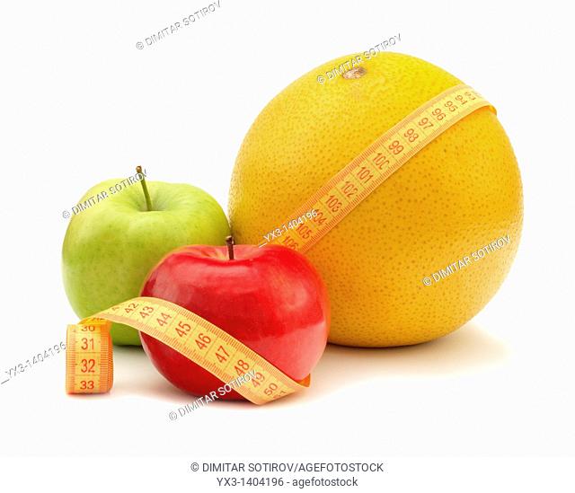 Fruits with measuring instrument on a white background