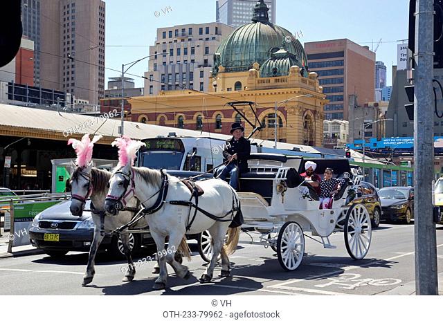 Sightseeing horse coach on Flinders Street, Central Melbourne, Victoria, Australia