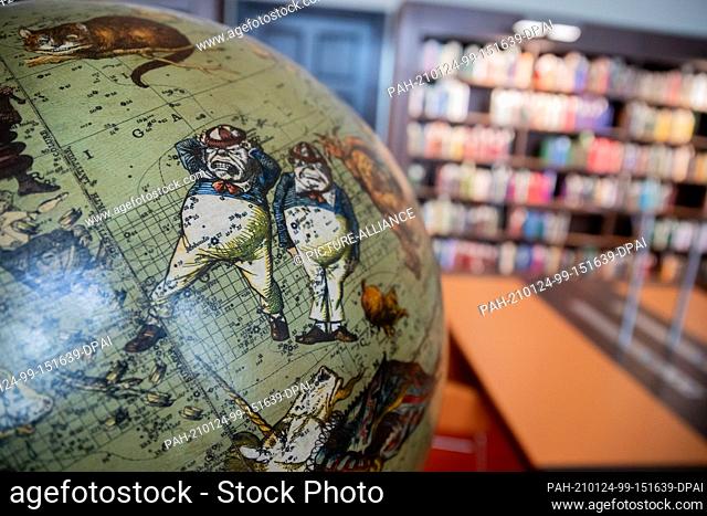 20 January 2021, Berlin: A globe with motifs from the children's book ""Alice in Wonderland"" stands in the reading room for children's and youth literature of...