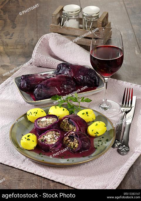 Two stuffed red cabbage roulade with boiled potatoes