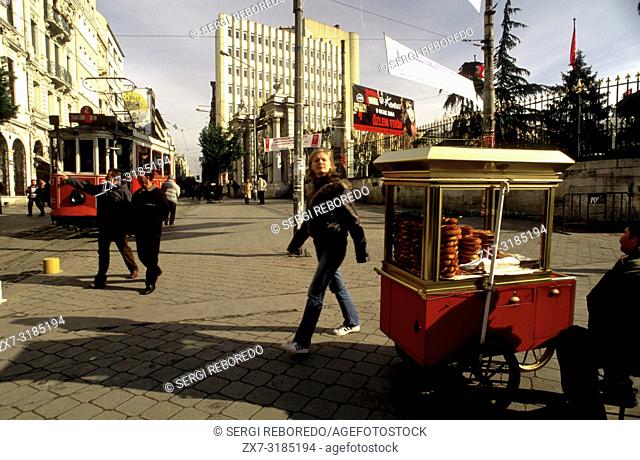 Historic Red Tram on Istiklal Caddesi, Beyoglu, Istanbul, Turkey. Simit stnd typical Açma bread selling