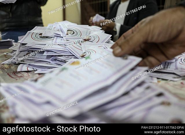 12 December 2023, Egypt, Cairo: Egyptian electoral workers count ballots at a polling station in Shoubra Secondary School For Boys at the end of the last day of...