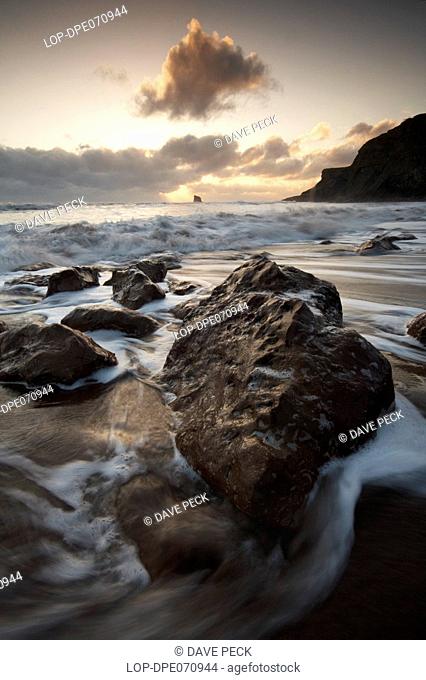England, North Yorkshire, Saltwick Bay, Waves rushing onto the beach at Saltwick Bay