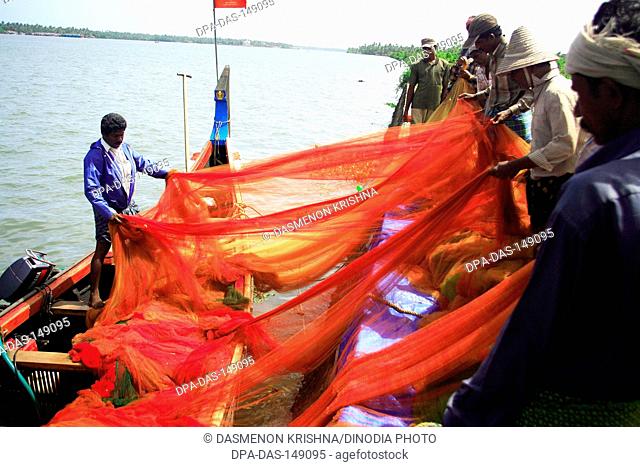 Fishermen cleaning  fishnet ; Vypeen ; Cochin ; Kerala ; India