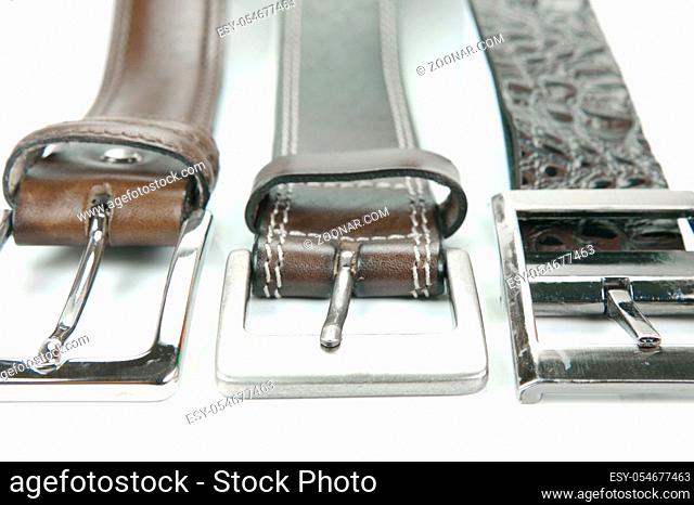Brown belts isolated against a white background