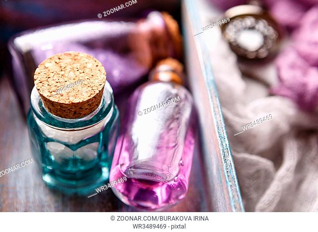 Bottle with aromatic lavender oil and sea salt in a wooden box. Close-up. Selective focus. Spa and perfume theme