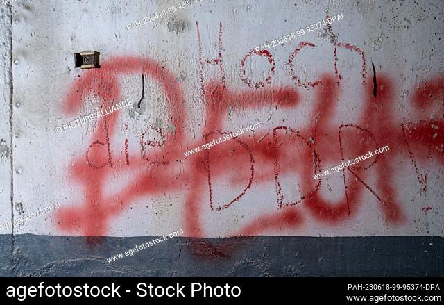 PRODUCTION - 14 June 2023, Saxony, Heinersgrün: ""Hail to the GDR!"" is written on a wall in a room in the last GDR border tower on Saxon soil near the Bavarian...
