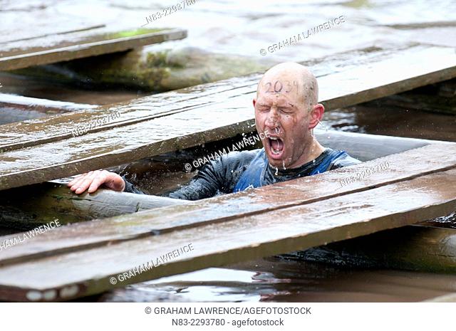 A contestant emerges from the freezing 'Water Tunnels' during the Tough Guy contest