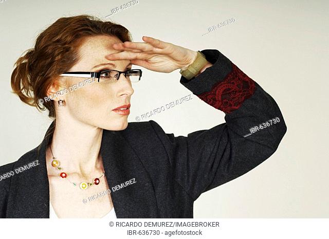 Businesswoman wearing eyeglasses looking ahead into the future