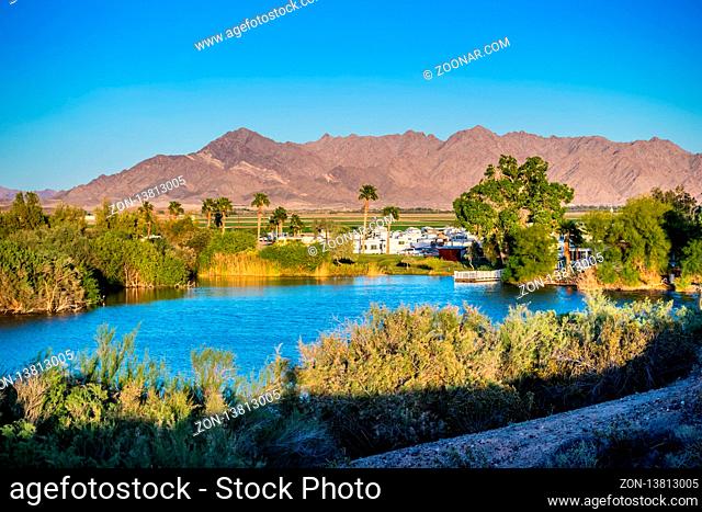 Yuma, AZ, USA - April 4, 2017: Clear path of bluish water surrounded by shrubs