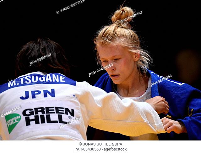 Megumi Tsugane (white, Japan) and Lea Reimann (blue, Germany) fight in the women's 63kg body weight competition at the Judo Grand Prix in the Mitsubishi...