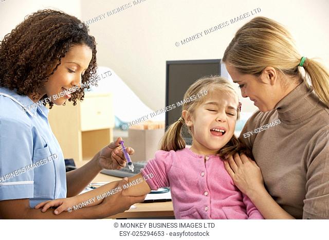 Nurse injecting child with mother