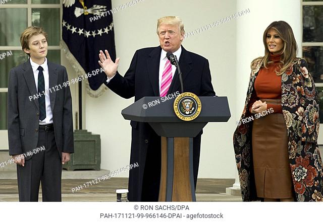United States President Donald J. Trump, center, makes remarks as Barron Trump, left, and and First Lady Melania Trump, right
