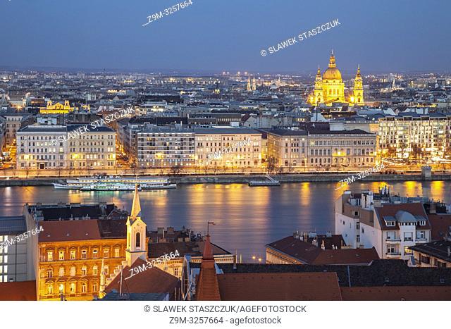 Night falls in Budapest, Hungary. St Stephen's cathedral dominates the skyline