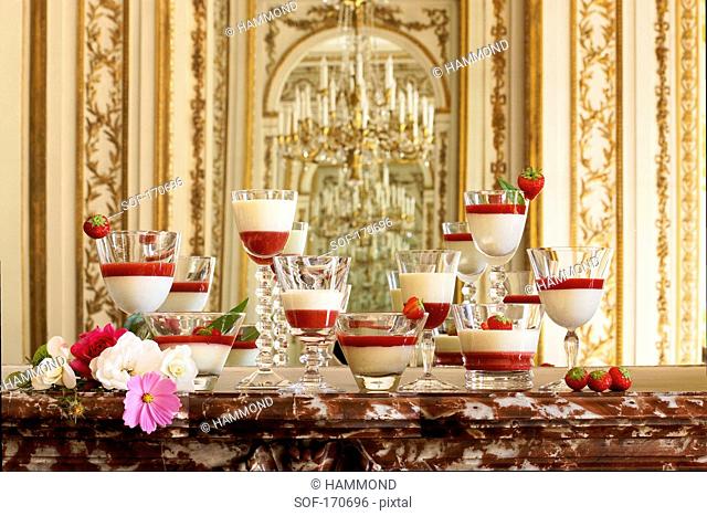Dishes of panacotta and strawberry puree in a luxurious decor