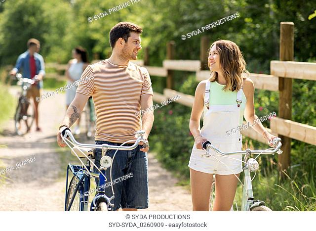 happy couple with fixed gear bicycles in summer