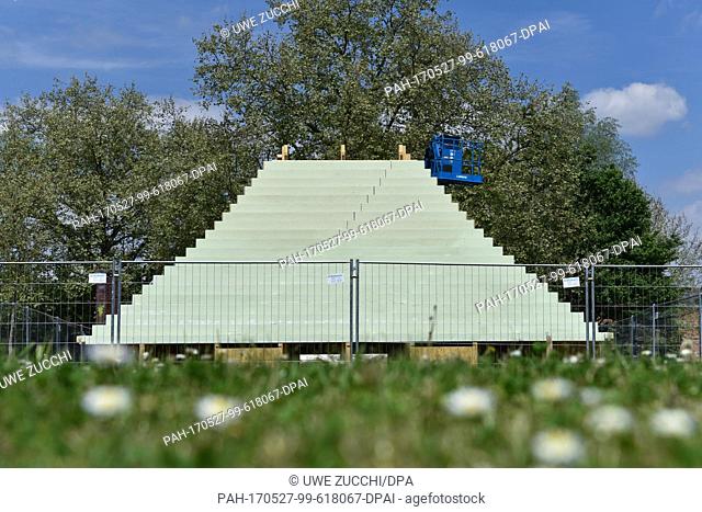 The not yet finished sculpture 'The Living Pyramid' by US American artist Agnes Denes is pictured behind a fence in the northern part of Kassel,  Germany